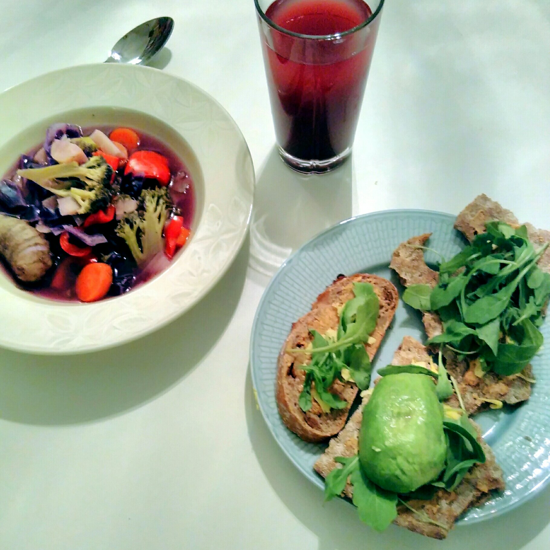 plant-based vegan dinner: rich vegetable soup, bread with peanut butter, rucola and avocado. Blueberry juice diluted with water, 1:5